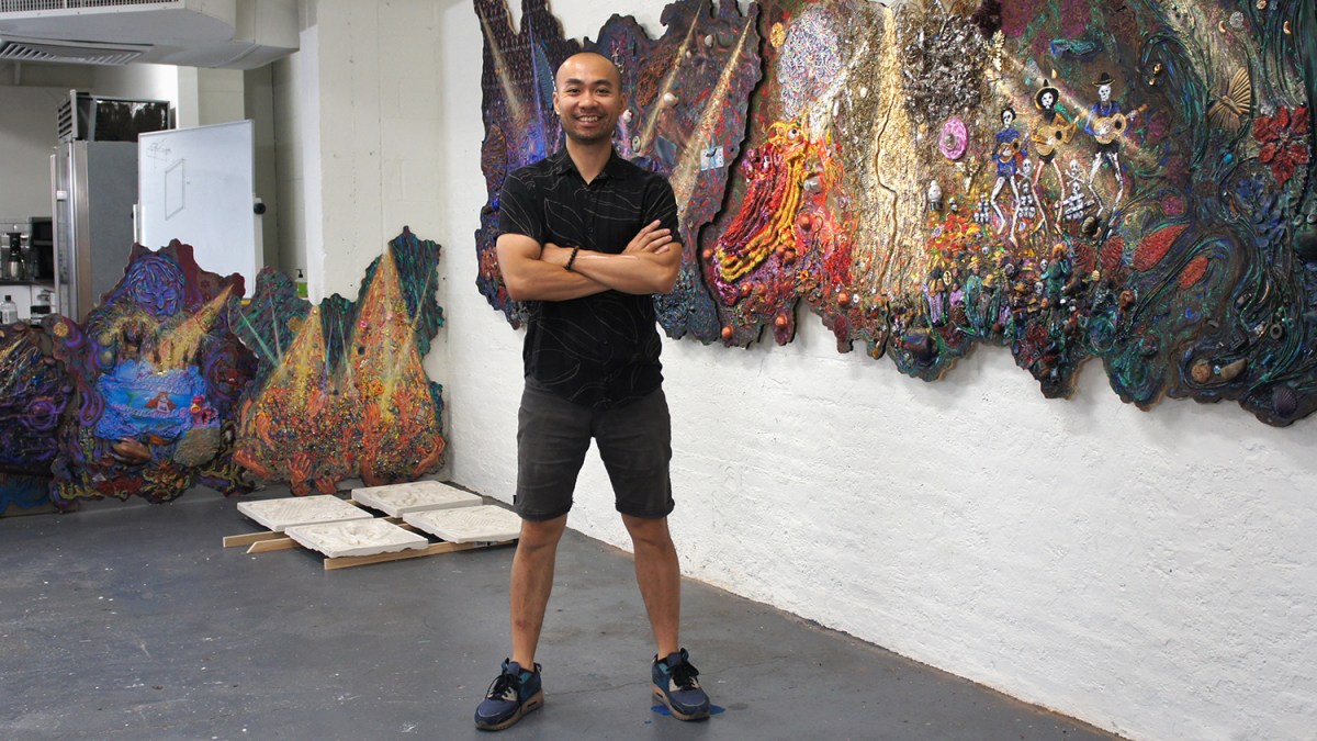 Artist Ye Qin Zhu standing in front of “A Stage Within a Stage” partially hung in his Brooklyn studio.